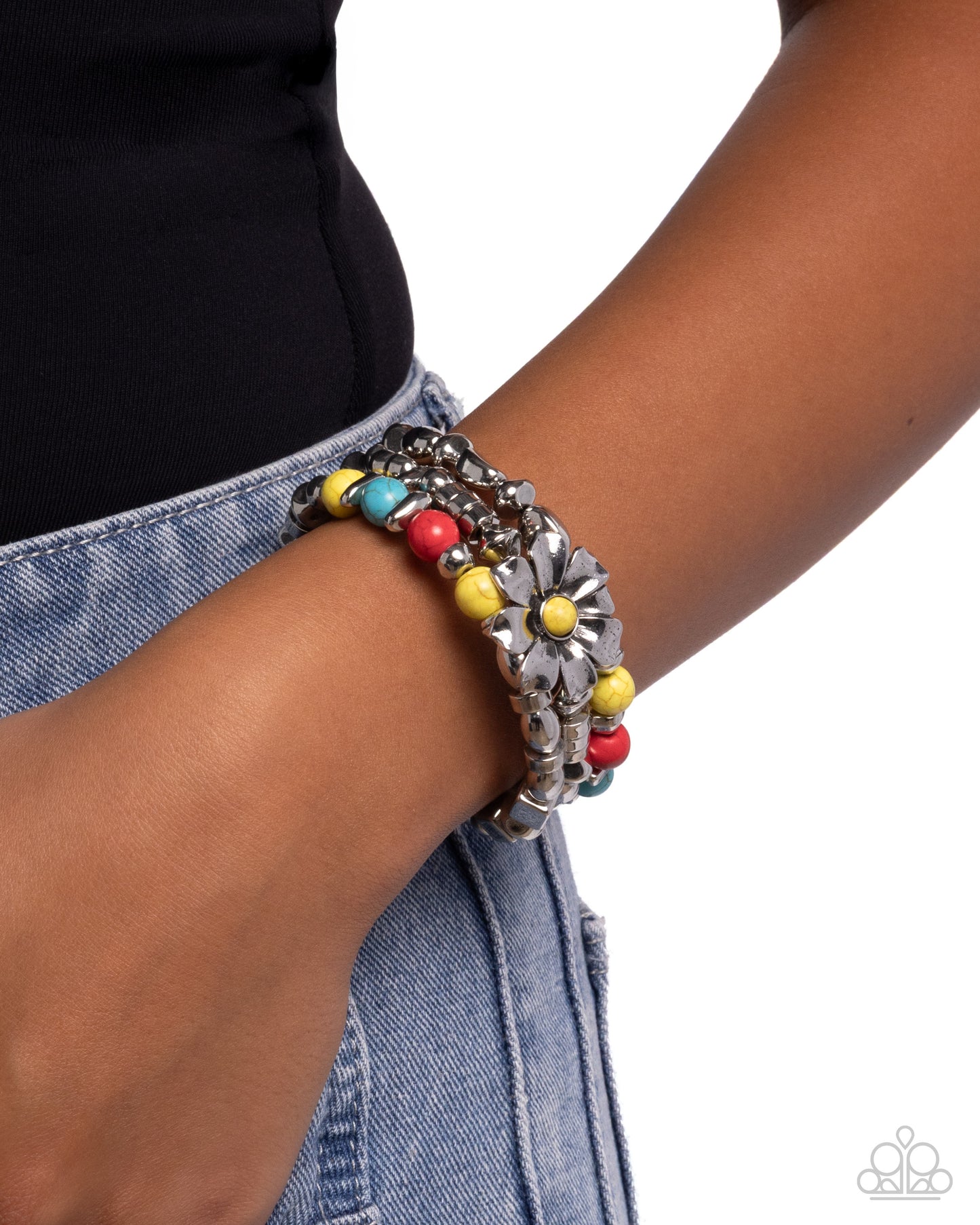 Bracelet with colorful beads on a wrist against a white background