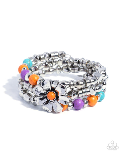 Stack of silver and colorful beaded bracelets on a white background