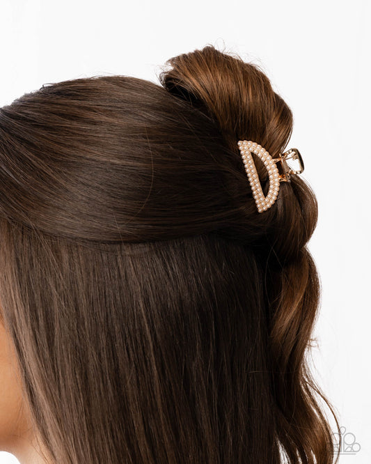 Hair bun with a decorative hair clip on a white background