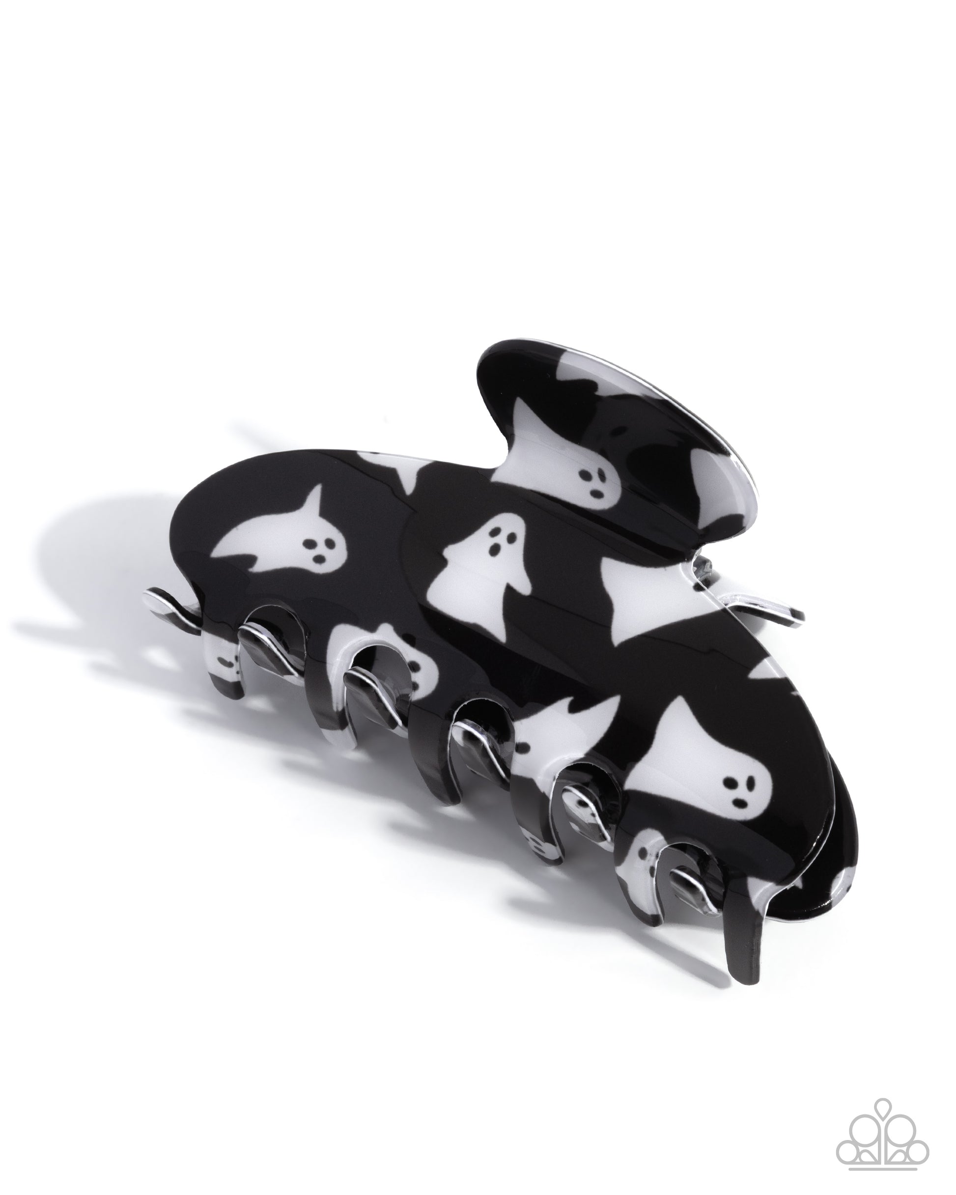 Black hair clip with white ghost designs on a white background