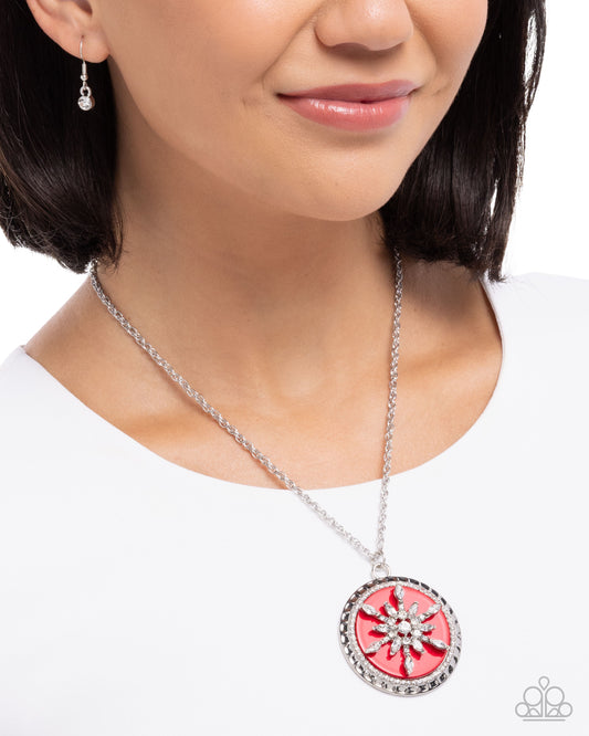 Necklace with a red and silver pendant worn by a model on a white background