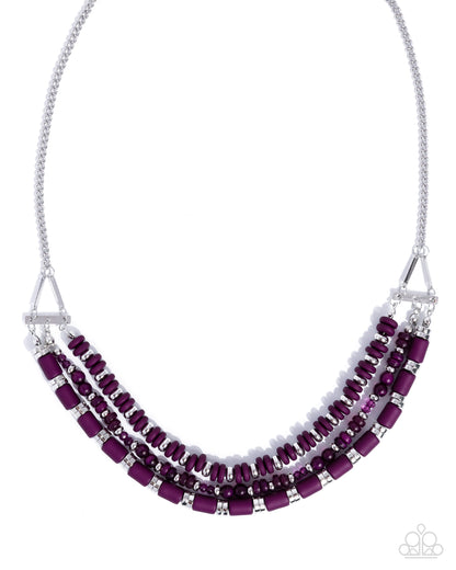 Necklace with purple beads and silver accents on a white background