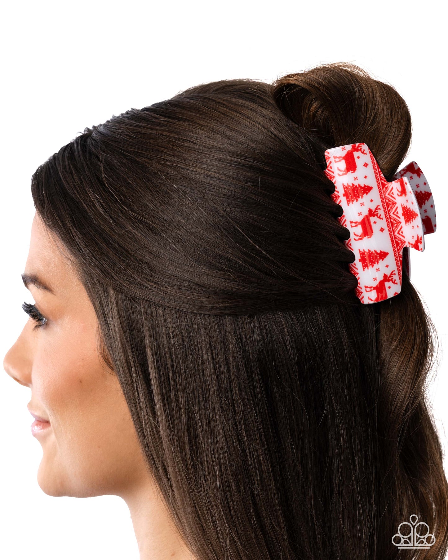Woman with brown hair styled in a bun with a red and white hair clip featuring Christmas tree patterns.