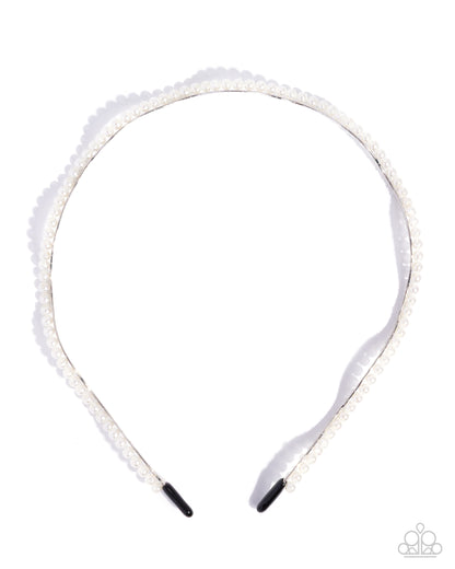 White headband with decorative elements on a white background