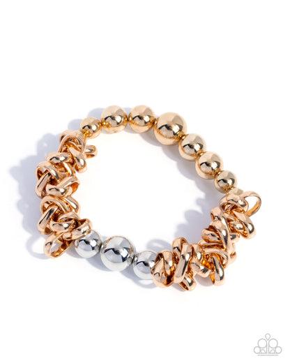 Gold and silver beaded bracelet on a white background