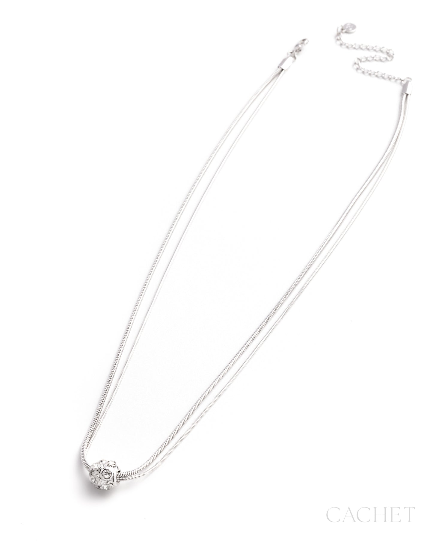 Silver necklace with a small pendant on a white background, branded 'Cachet'.