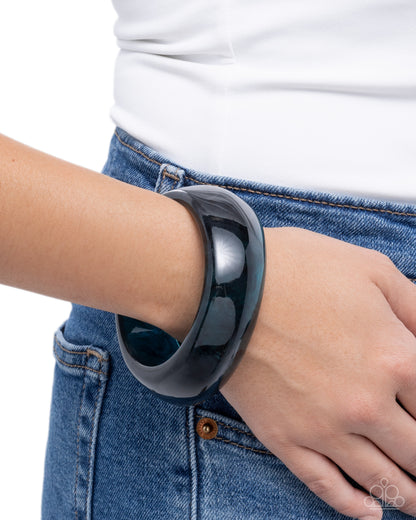 Person wearing a black smartwatch on their wrist with a white background