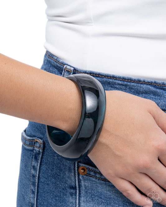 Person wearing a black smartwatch on their wrist with a white background
