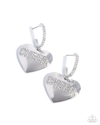 Heart-shaped silver earrings with clear gemstones on a white background