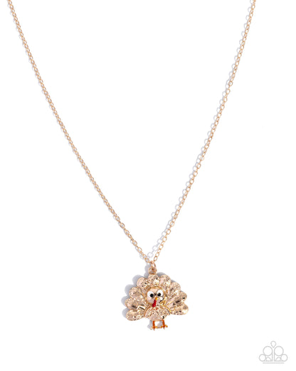 Turquoise and gold necklace on a white background