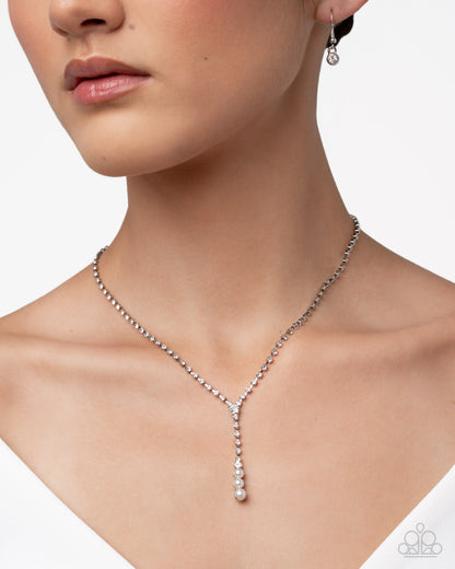 Necklace and earring set on a model with a white background