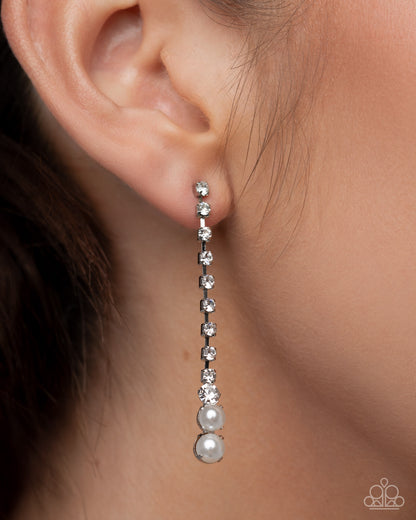 Earring worn on an ear with a blurred background