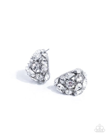 Pair of silver earrings with clear gemstones on a white background