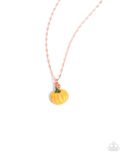 Pumpkin-shaped pendant on a pink chain against a white background