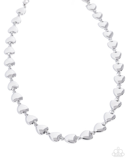 Silver heart-shaped beaded necklace on a white background