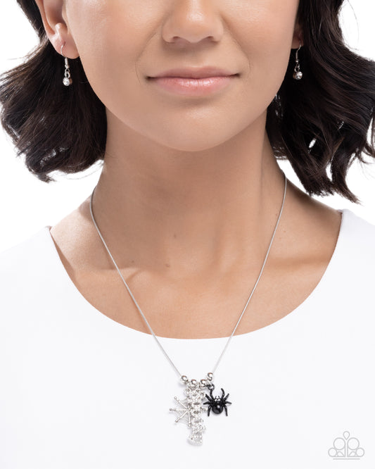 Necklace with spider pendant worn by a model on a white background
