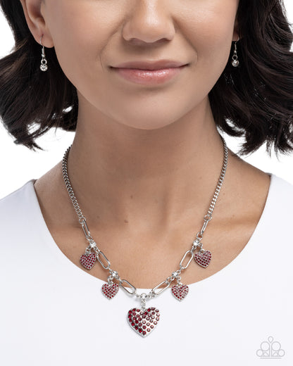 Necklace with heart-shaped charms worn by a model on a white background