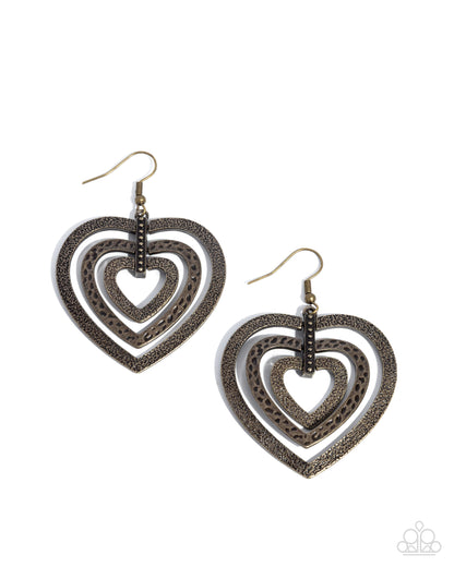 Heart-shaped earrings with intricate designs on a white background