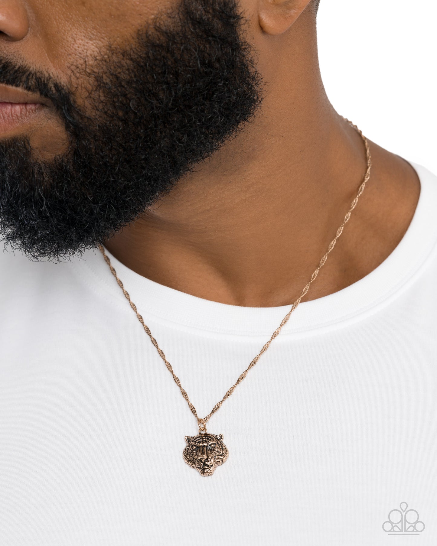 Necklace with a lion head pendant worn by a person on a white background