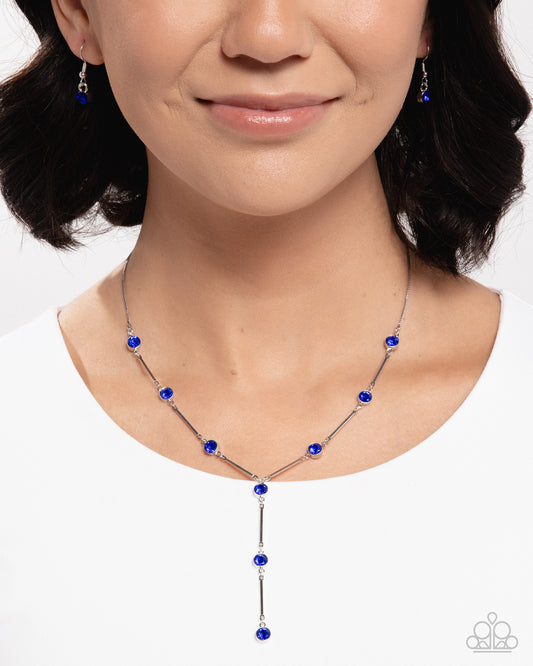 Woman wearing a blue beaded necklace and earrings on a white background