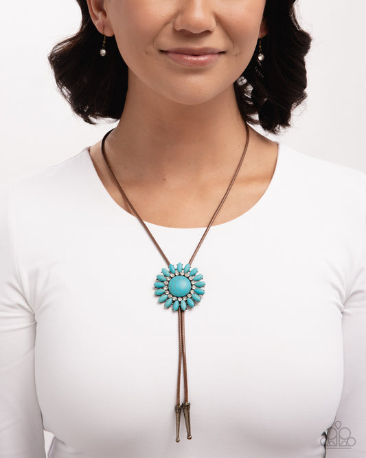 Woman wearing a turquoise bolo tie necklace on a white background