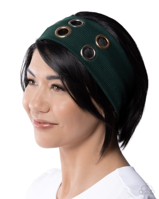 Person wearing a green headband with circular cutouts on a white background