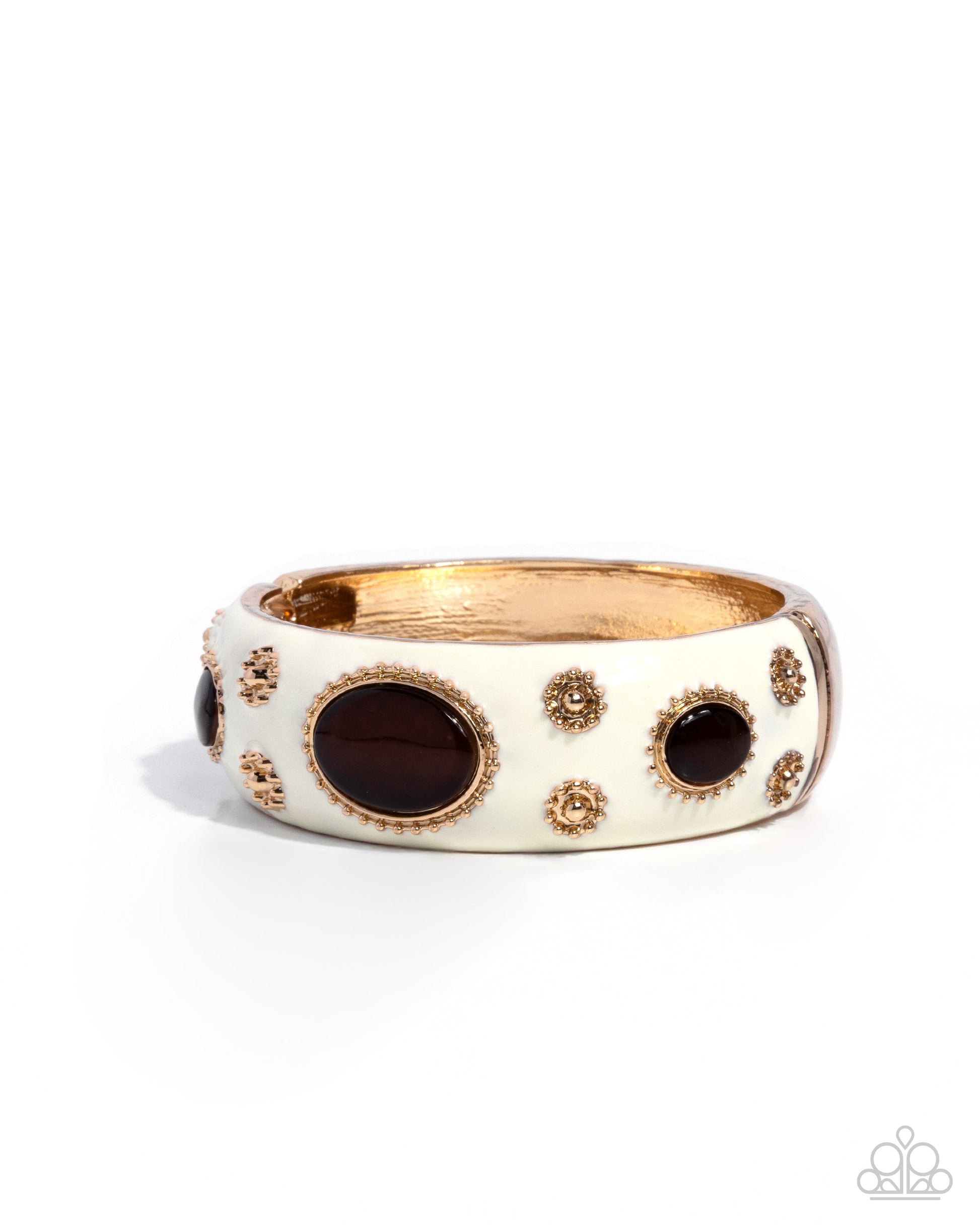 Gold and white ring with black stones on a white background