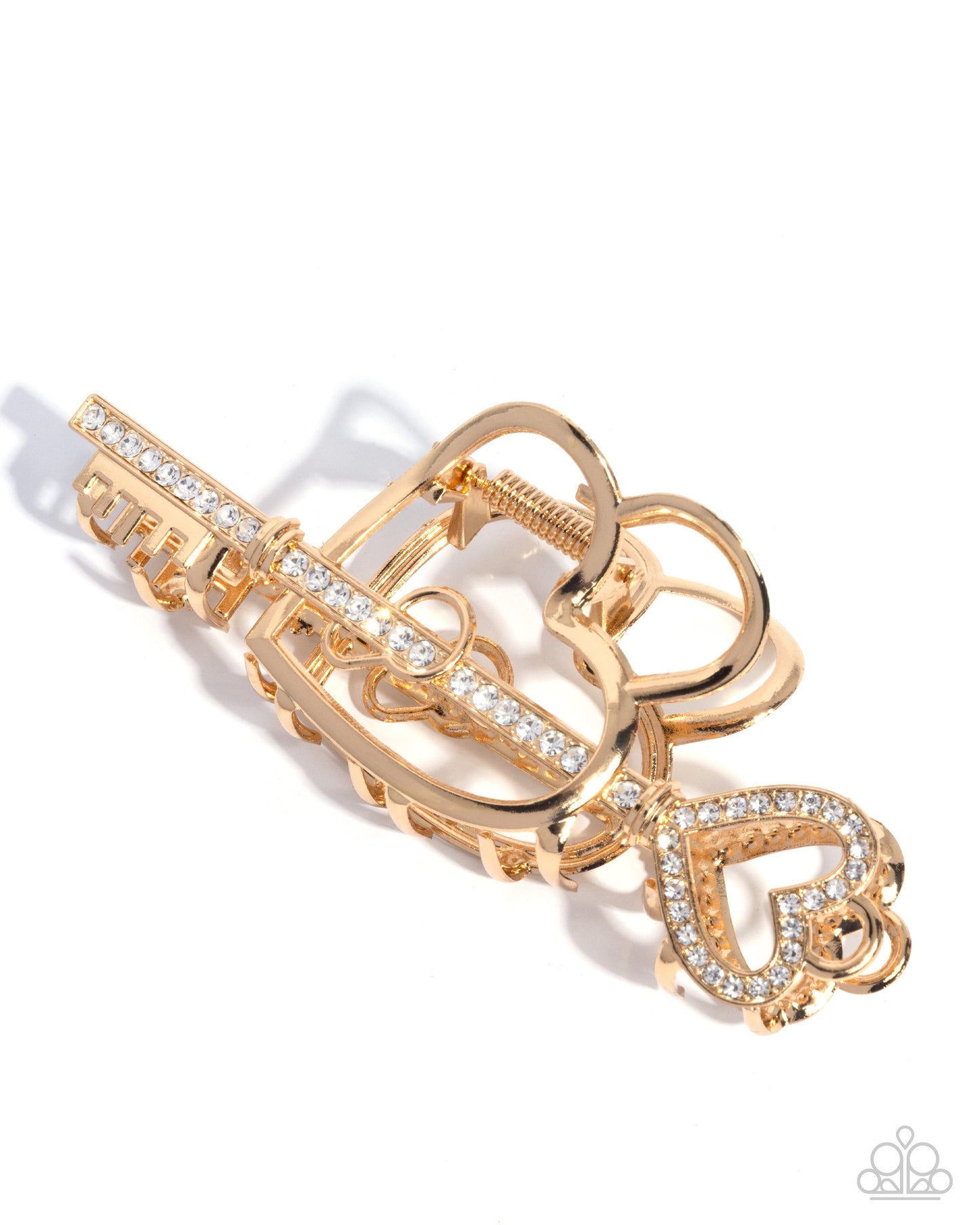 Gold key-shaped brooch with heart design on a white background