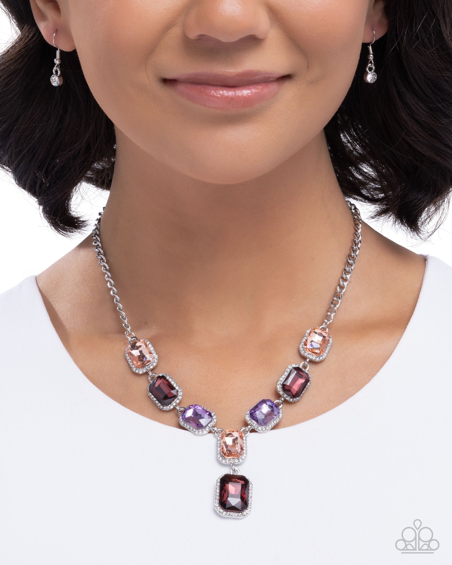 Necklace with multicolored gemstones worn by a model on a white background