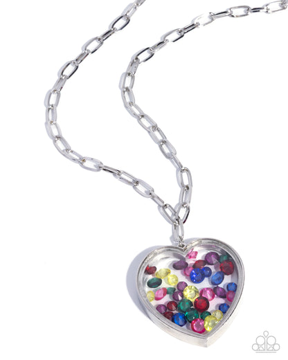 Heart-shaped locket with colorful stones on a silver chain against a white background