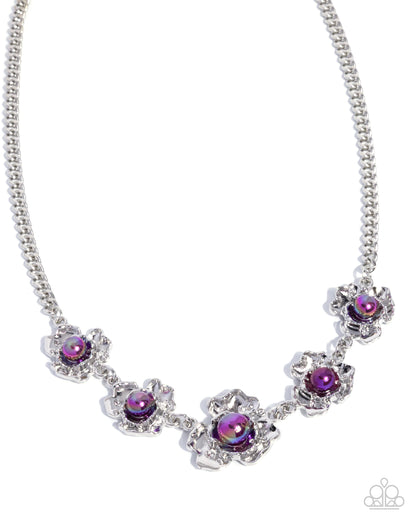 A silver-tone ball chain necklace featuring five decorative floral clusters, each with a round iridescent purple gemstone surrounded by clear rhinestones, shown on a plain white background.