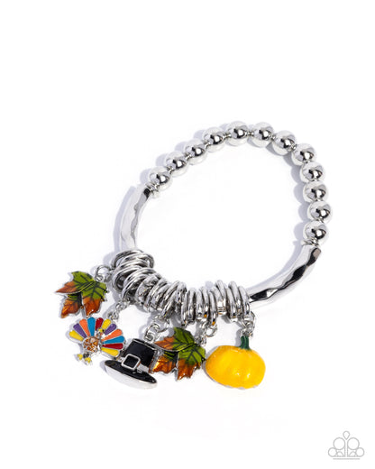 Silver bracelet with colorful charms on a white background