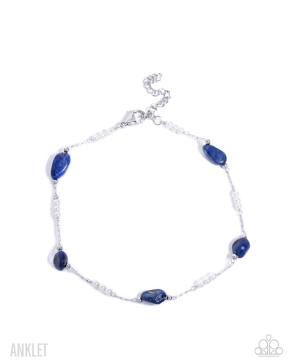 Silver anklet with blue beads on a white background