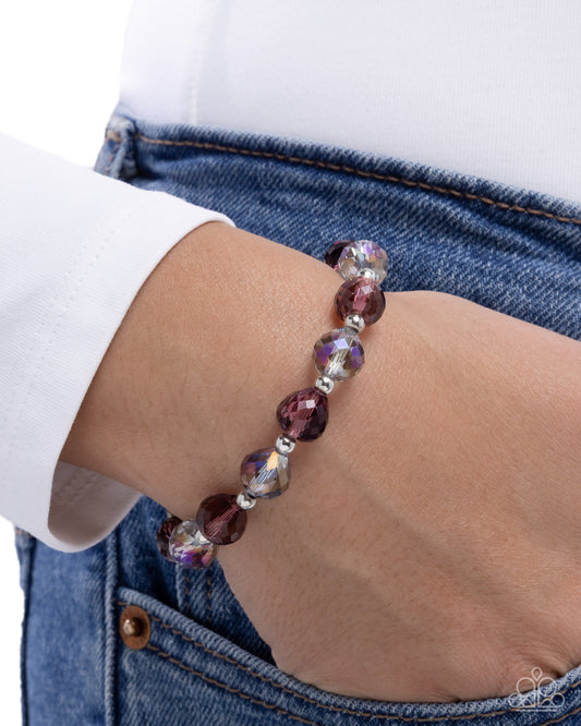 Beaded bracelet on a wrist with a white shirt and blue jeans background