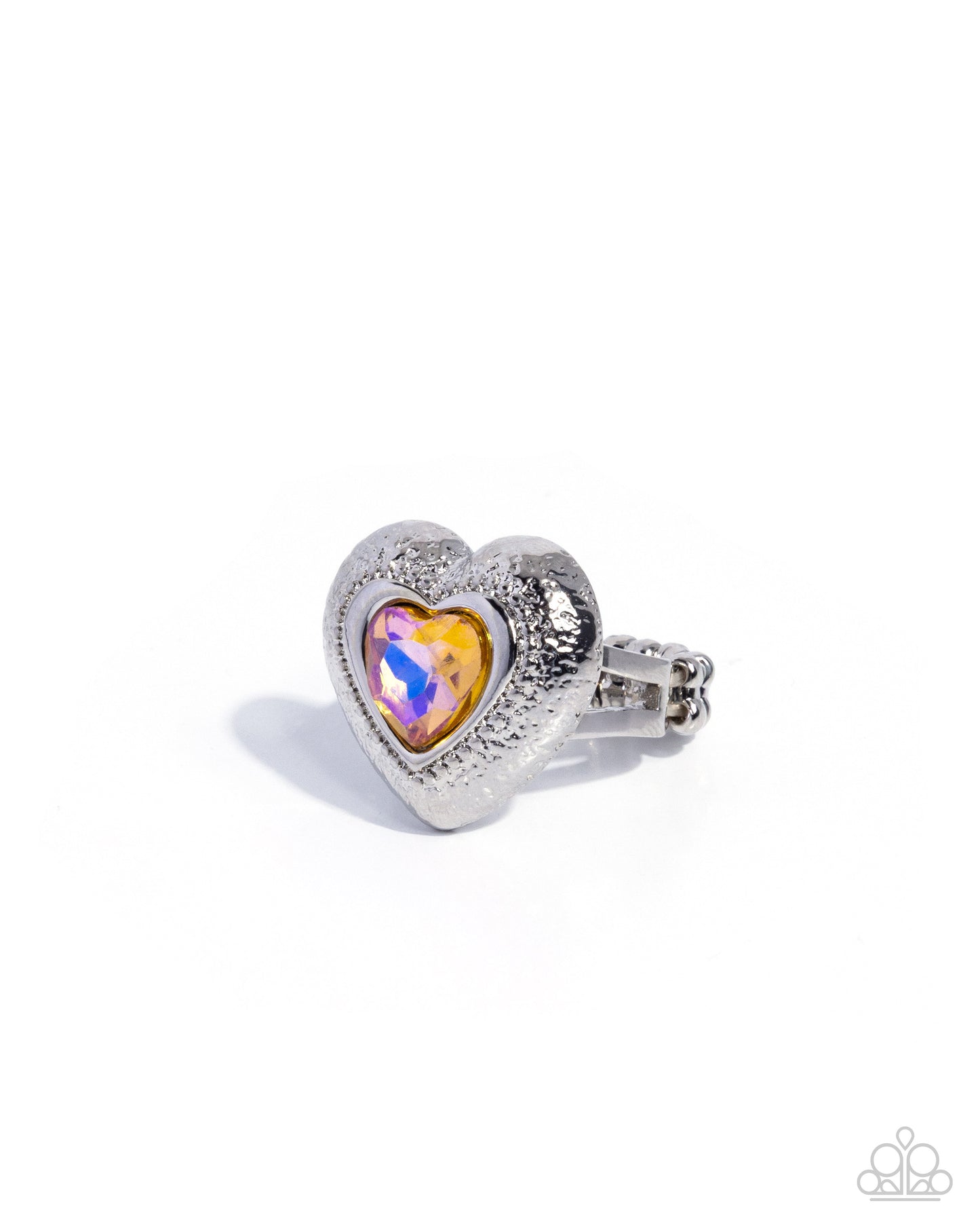 Heart-shaped ring with a colorful gem on a white background