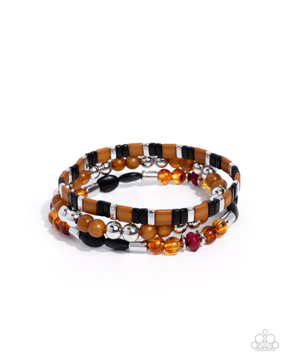 Stack of beaded bracelets with brown, black, silver, and red beads on a white background