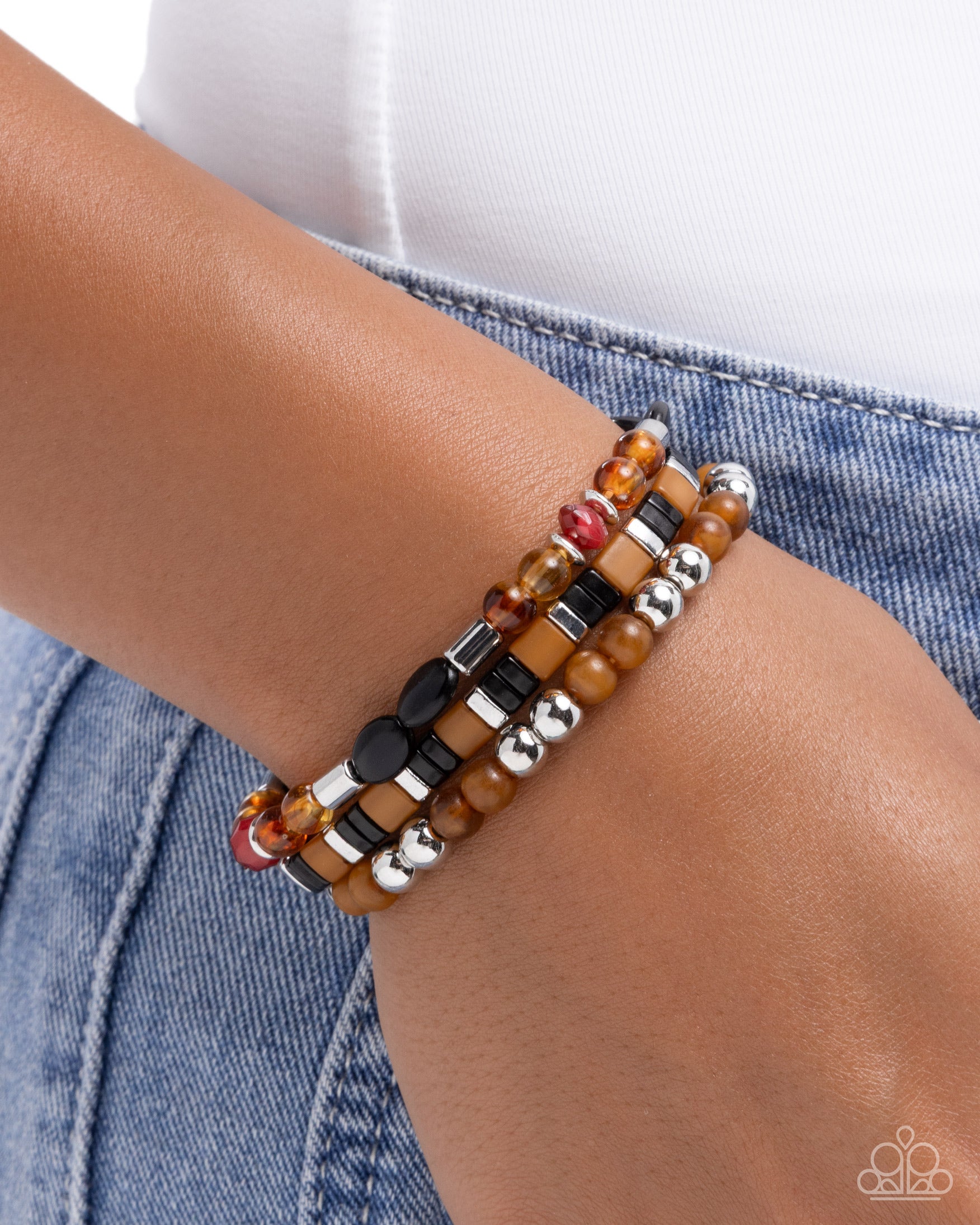Multistrand beaded bracelet on a wrist with a denim background