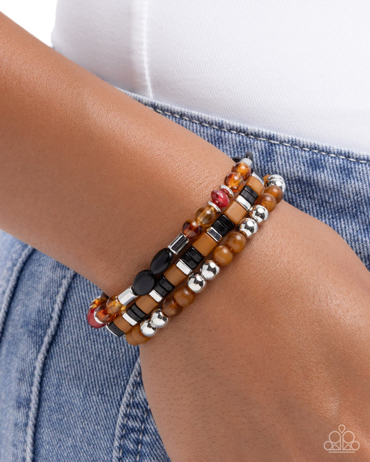 Multistrand beaded bracelet on a wrist with a denim background