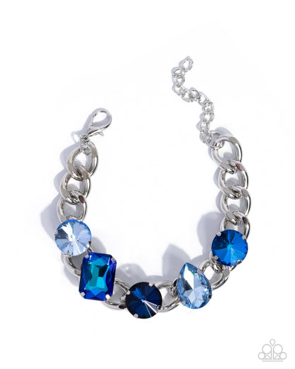 Silver bracelet with blue gemstones on a white background