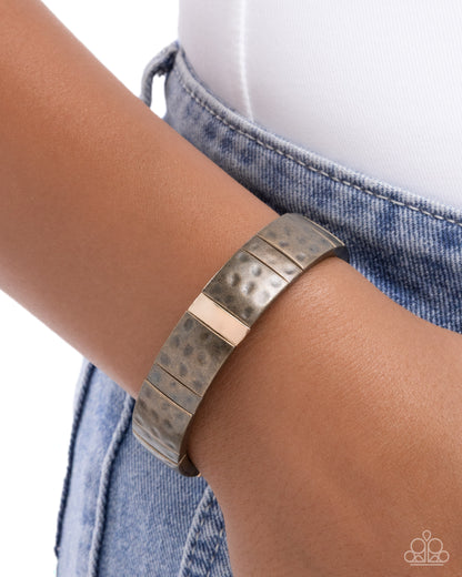 Silver bracelet on a wrist with a denim background