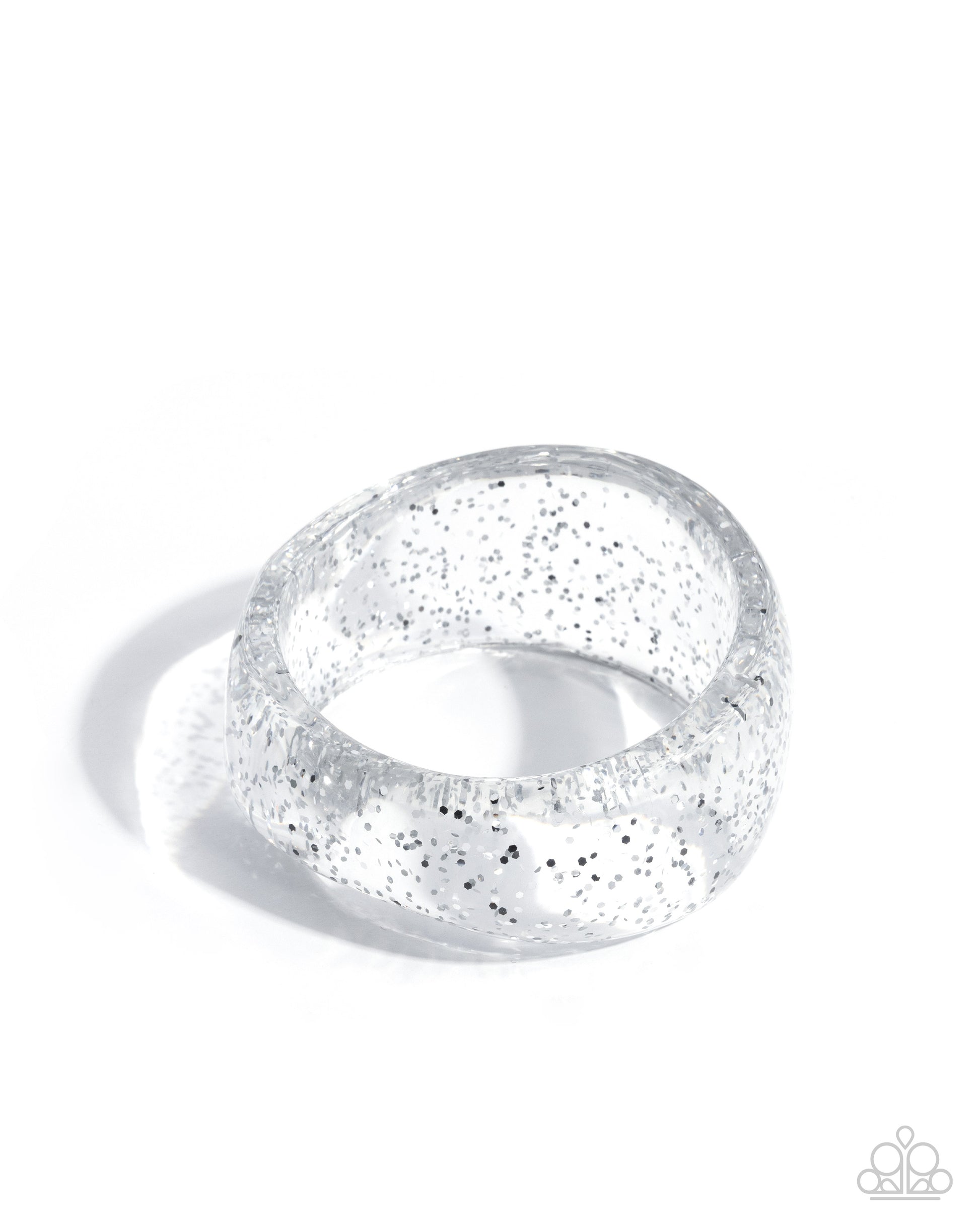 Silver ring with glittery texture on a white background