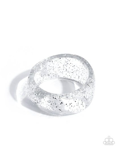 Silver ring with glittery texture on a white background