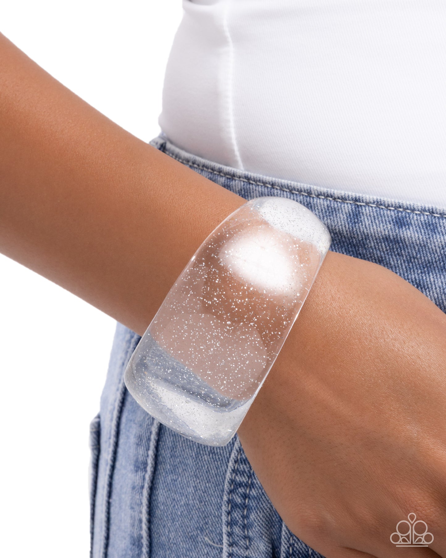 Clear bracelet on a wrist with a white background