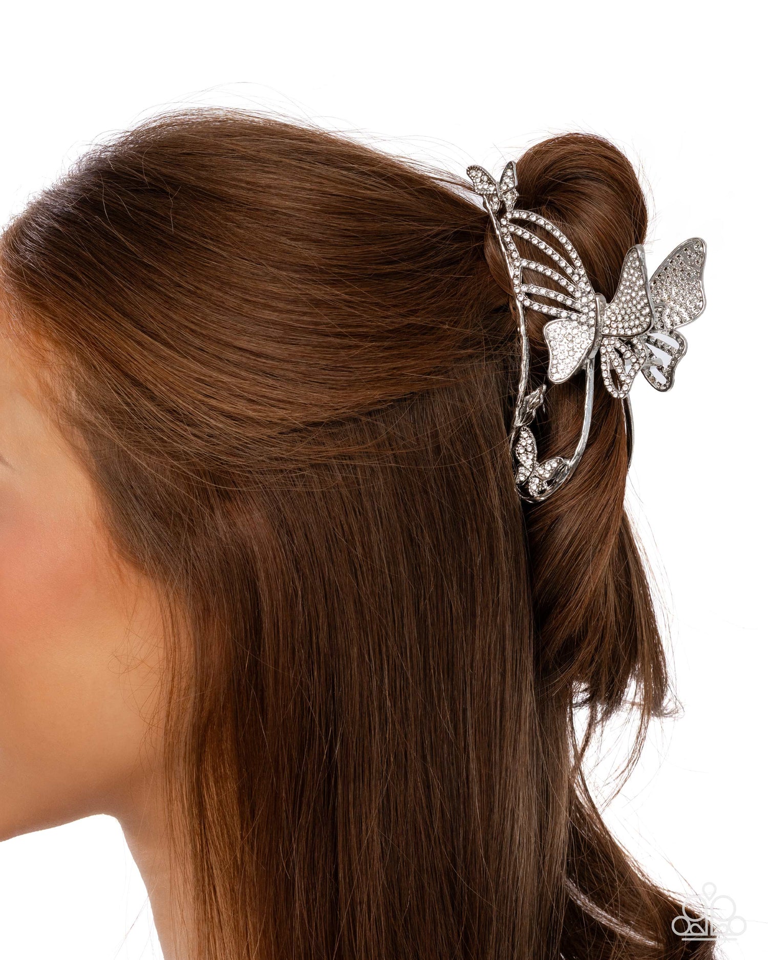 Butterfly hair clip in a person's hair on a white background