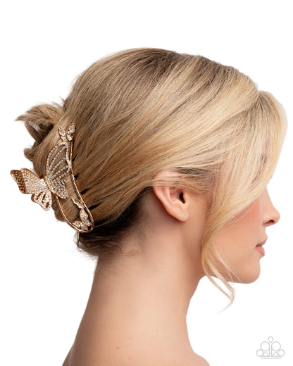 Blonde hair styled with a decorative hairpiece on a white background