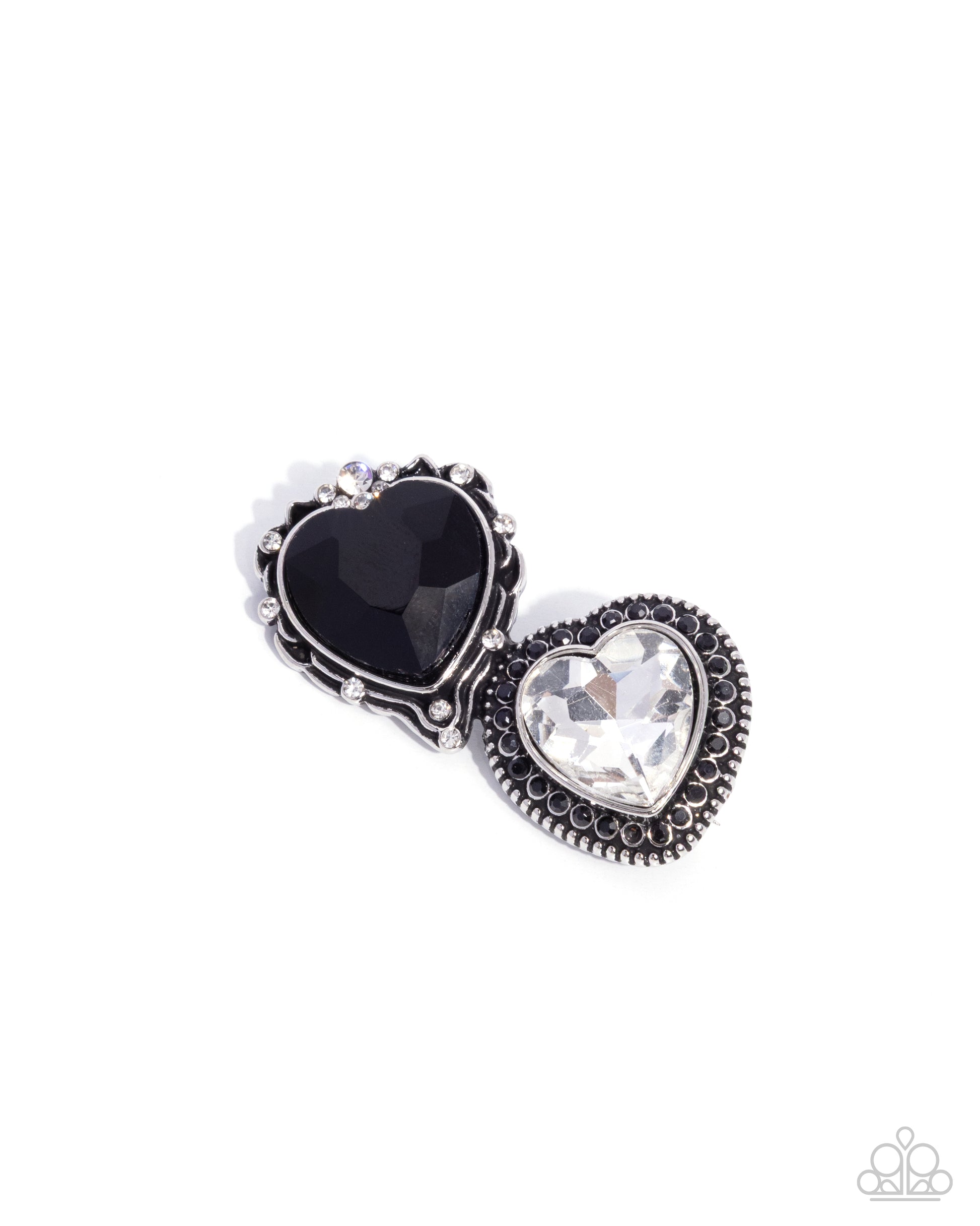 Jewelry set with black and clear heart-shaped stones on a white background
