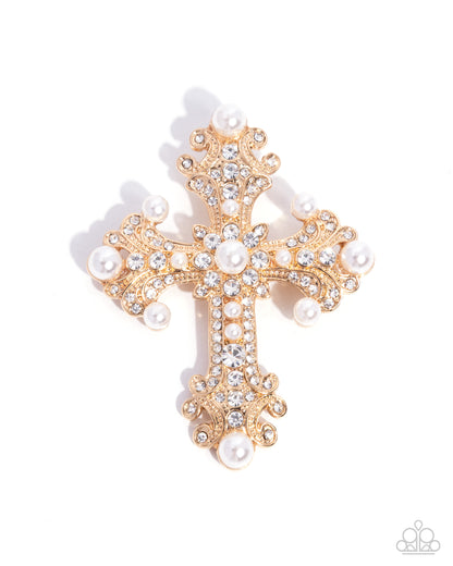 Gold cross brooch with pearls and crystals on a white background