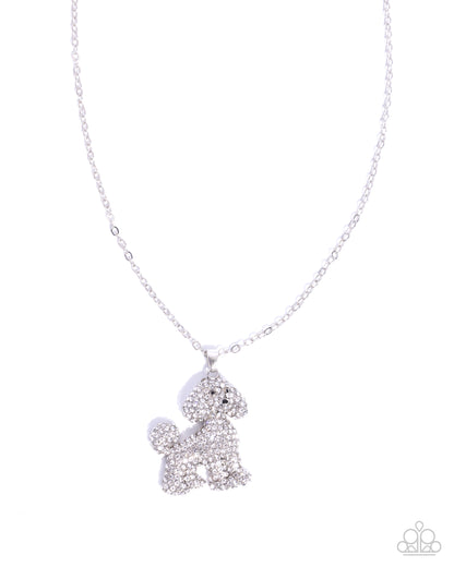 Silver poodle-shaped pendant on a chain against a white background