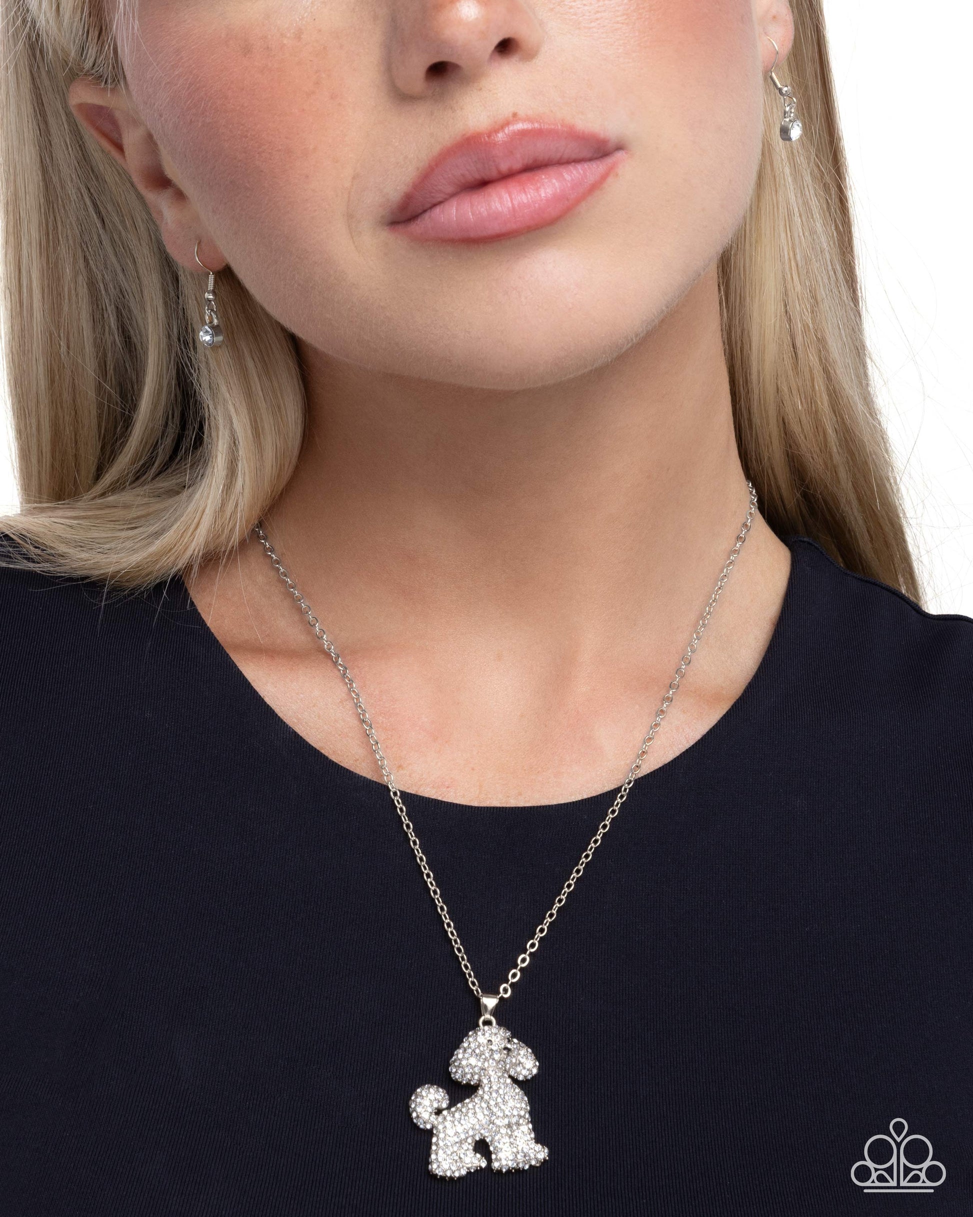 Necklace with a dog-shaped pendant worn by a person on a white background