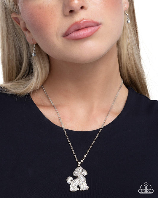 Necklace with a dog-shaped pendant worn by a person on a white background